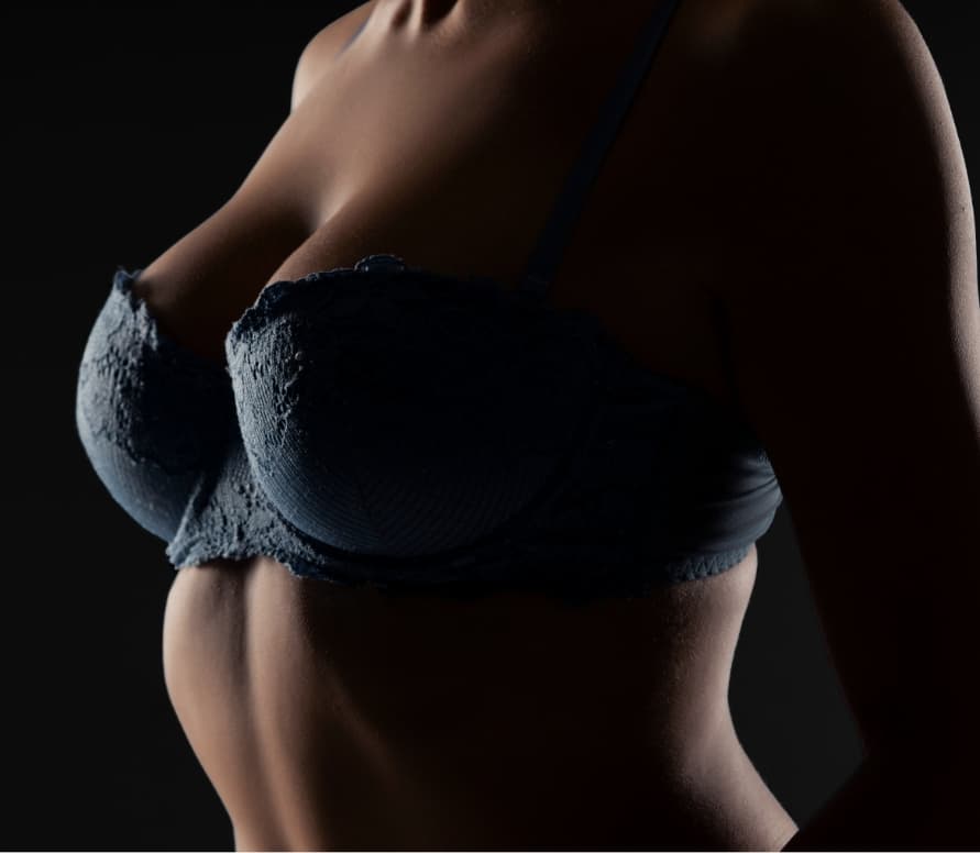Model wearing black lacey bra