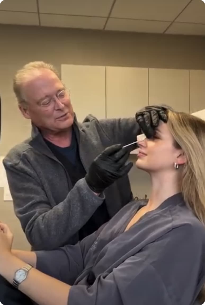 Doctor applying medspa procedure to patients face