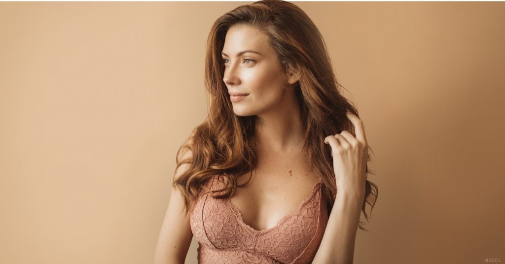 Woman after cosmetic breast surgery procedure. (Model)