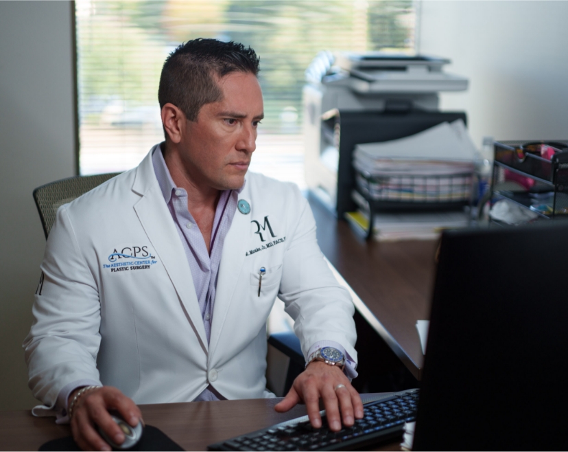 Dr. Rolando Morales typing on computer