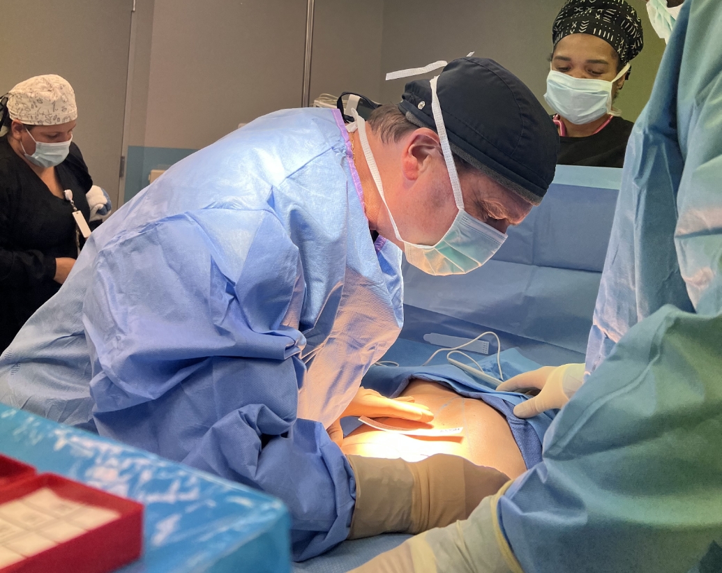 Dr. German Newall preforming surgery in the or