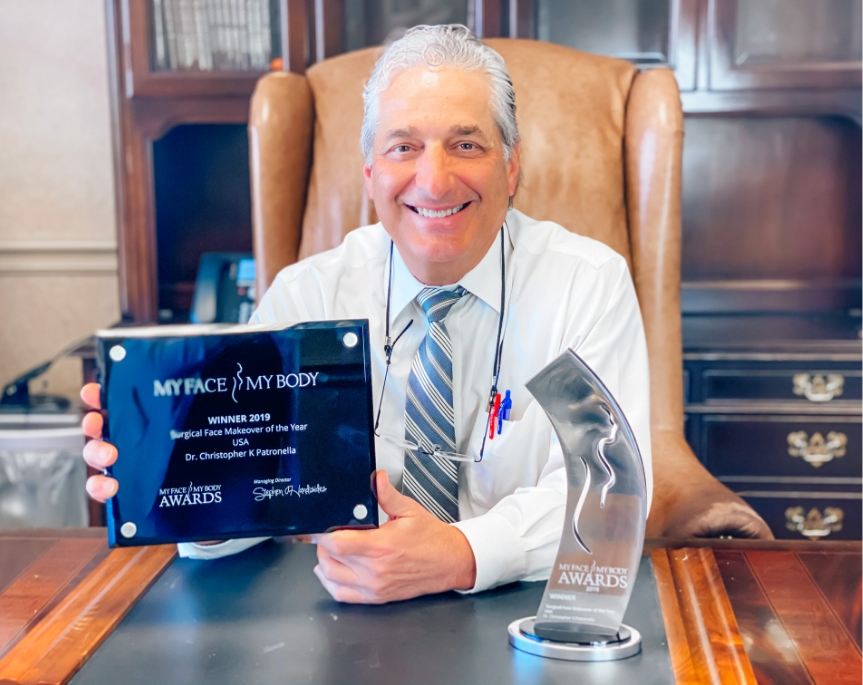 Dr. Christopher Patronella holding award