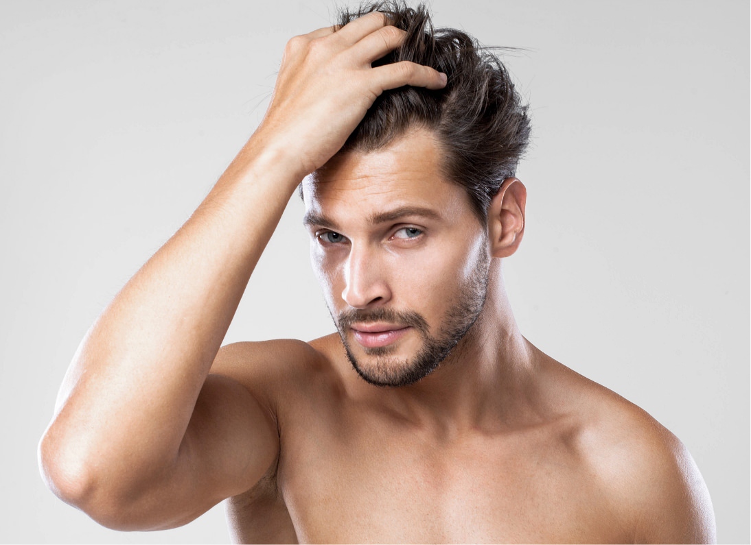 shirtless man running fingers through hair