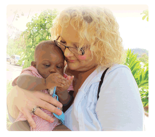 ACPS SurgiCentre nurse, Becky Tittle, with a young patient at a medical clinic in Honduras. Becky enjoys participating on medical mission trips to provide medical supplies, food, and clothing to individuals living in low-income regions of the world.