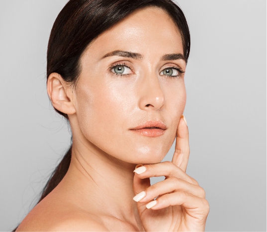 Model touching chin looking at camera