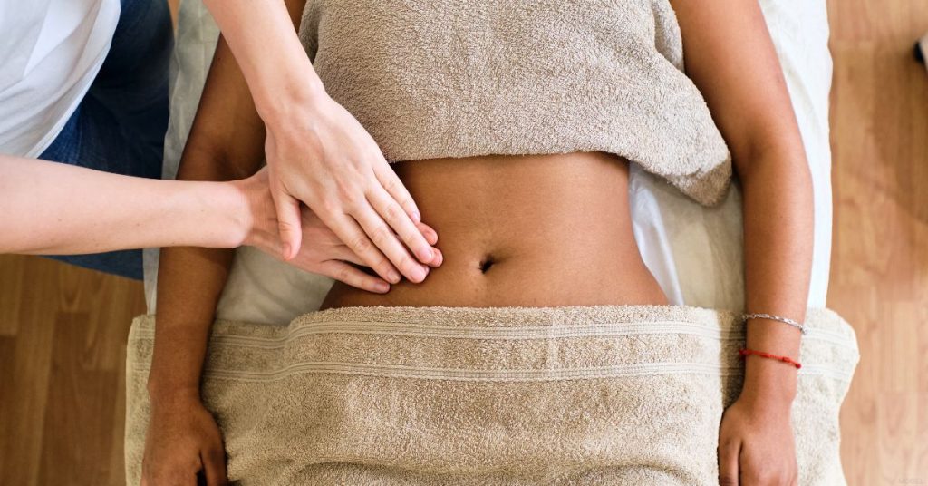 Woman receiving a stomach massage (models)