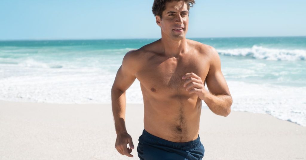 Man running on the beach (model)