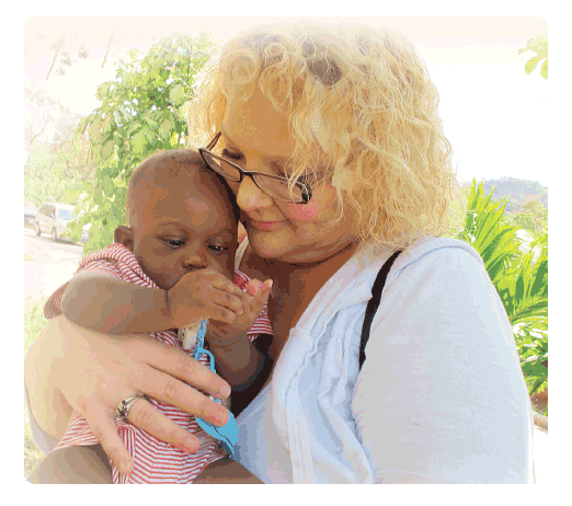 ACPS SurgiCentre nurse, Becky Tittle, with a young patient at a medical clinic in Honduras. Becky enjoys participating on medical mission trips to provide medical supplies, food, and clothing to individuals living in low-income regions of the world. 